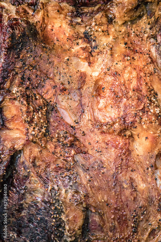 detail of cooked beef, vertical background image of roasted meat detail of cooked beef, vertical background image of roasted meat