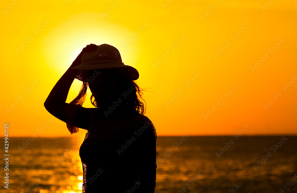 Girl in a hat by the sea