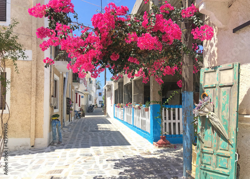 Street in the Greek village of Kardamena on the island of Kos. Bright bougainvillea flowers adorn the city. 
