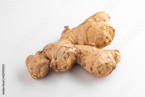 Close view on a ginger root on white background