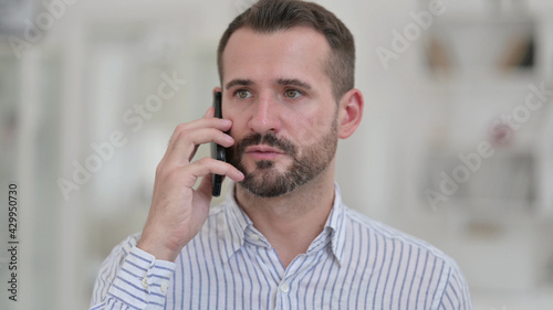 Portrait of Cheerful Young Man Talking on Phone 