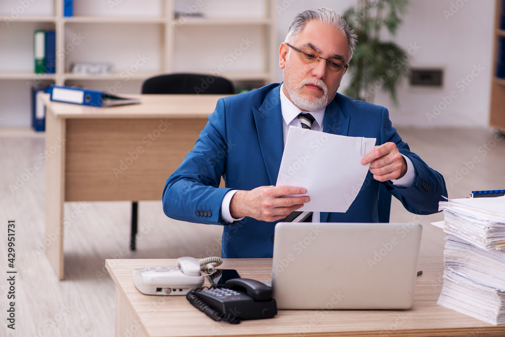 Old male employee and too much work in the office Old male employee and too much work in the office