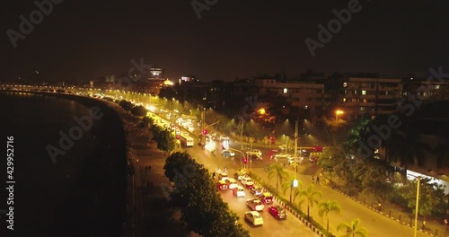 An aerial view with cinematic drone movement of the iconic Marine Drive nightlife with Air India and Trident Hotel buildings in sight. photo