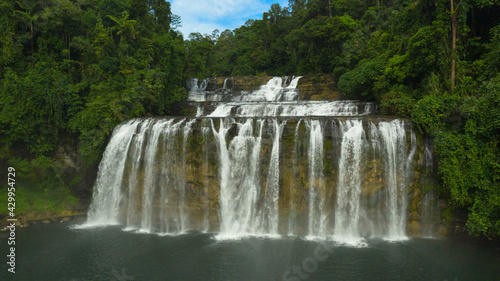 Beautiful waterfall in green forest, top view. Tropical Tinuy-an Falls in mountain jungle, Philippines, Mindanao. Waterfall in the tropical forest.