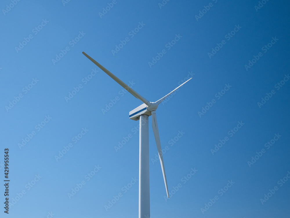 A wind turbine near Workington on the Solway Coast, Cumbria, UK. Taken on a sunny day with a clear blue sky. A wind turbine near Workington on the Solway Coast, Cumbria, UK. Taken on a sunny day with a clear blue sky.
