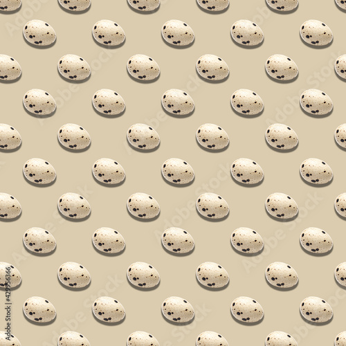 Seamless pattern of quail eggs on beige background