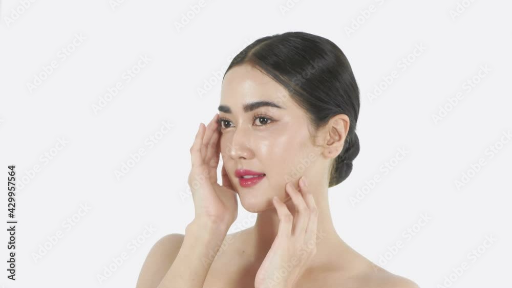 Beauty concept of 4k Resolution. A girl caressing her face on a white background. Beauty concept of 4k Resolution. A girl caressing her face on a white background.