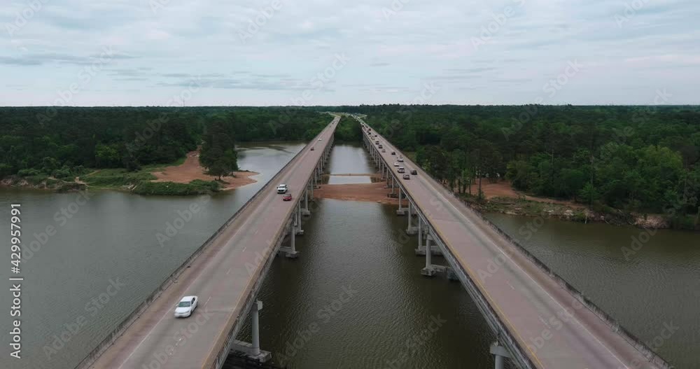 Aerial of cars driving on bridge that crosses over the San Jacinto River in Houston, Texas Aerial of cars driving on bridge that crosses over the San Jacinto River in Houston, Texas