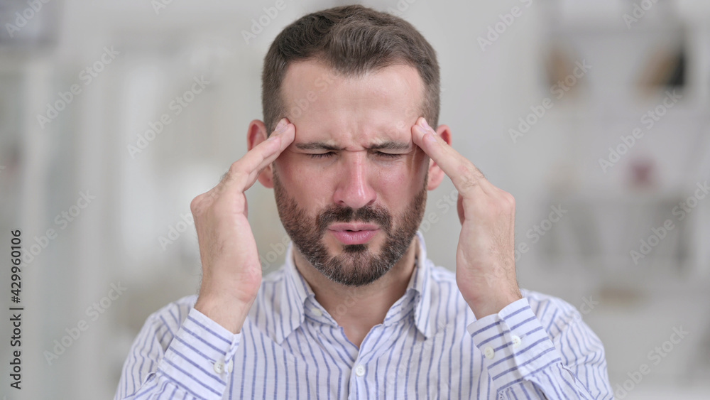 Obraz premium Portrait of Tired Young Man having Headache