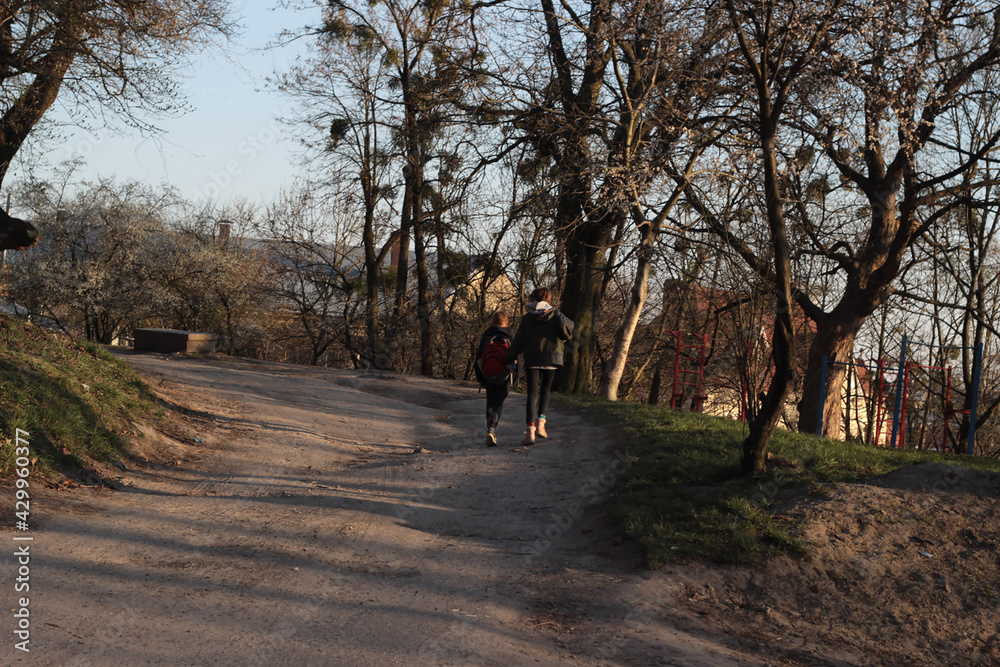 children go to the city through the woods on a dirt road