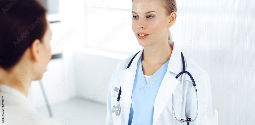 Woman - doctor consults her female patient in clinic. Medicine concept Woman - doctor consults her female patient in clinic. Medicine concept