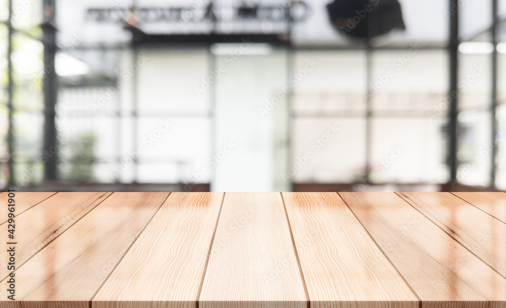 Empty wooden table top with lights bokeh on blur restaurant background. Empty wooden table top with lights bokeh on blur restaurant background.