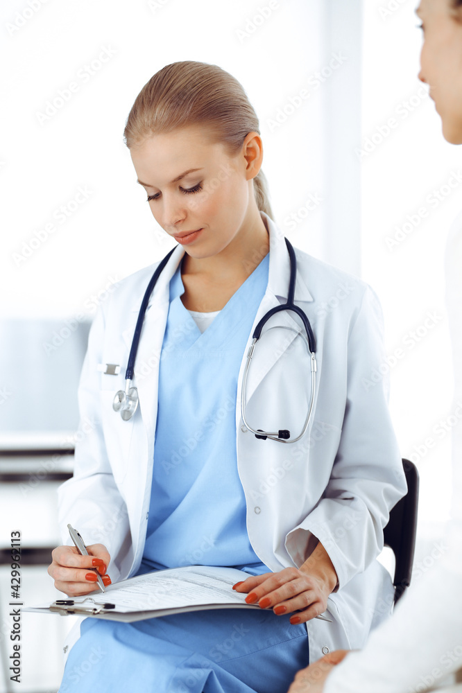 Woman - doctor consults her female patient while using clipboard and medication history record. Medicine concept Woman - doctor consults her female patient while using clipboard and medication history record. Medicine concept
