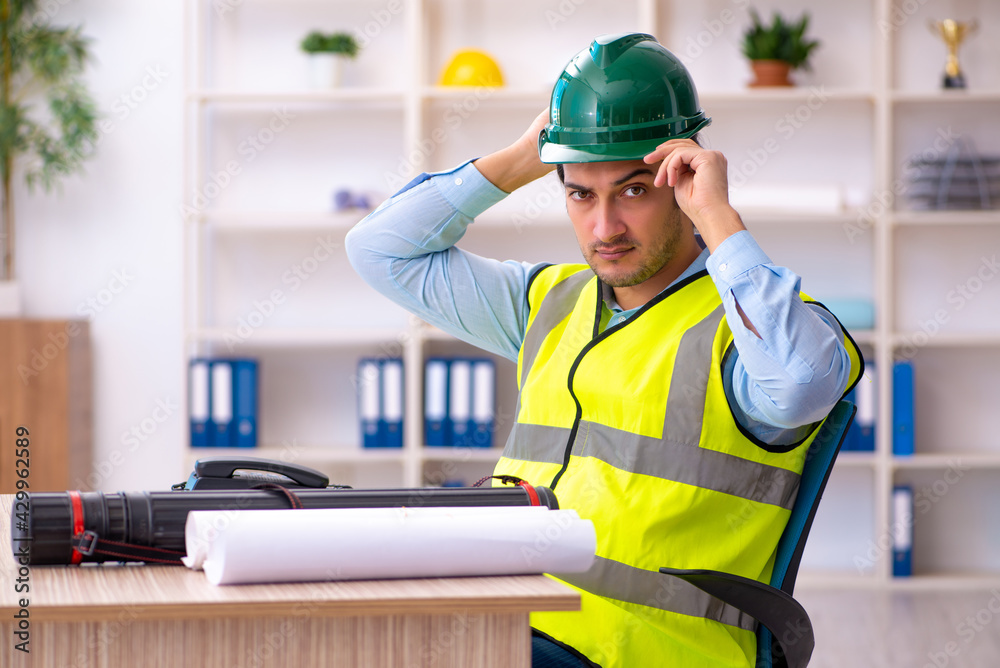 Young male architect working in the office Young male architect working in the office