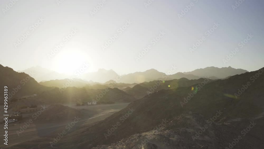Rocky landscape of desert with beautiful bright sunshine in front, handheld Rocky landscape of desert with beautiful bright sunshine in front, handheld