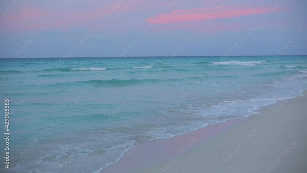 Beautiful Green Blue Ocean. View of Waves on the Beach at Sunset. White Sand. Beautiful Green Blue Ocean. View of Waves on the Beach at Sunset. White Sand.