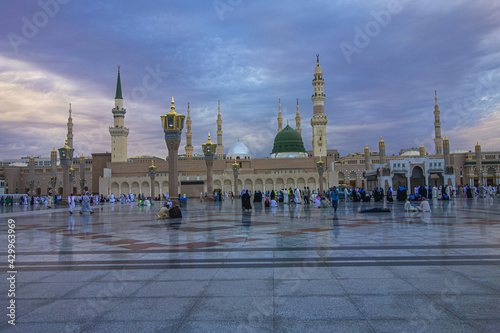 Delightful shot of Masjid Al Nabawi at sunset time along with dark moody clouds and the Green Dome