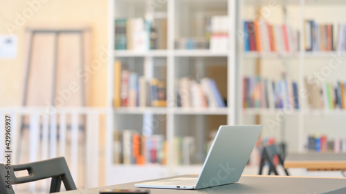 Empty Library with Open Laptop on Table