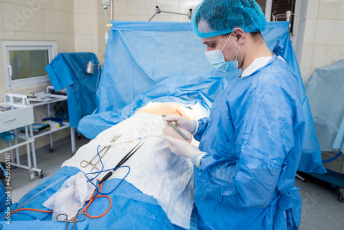 Breast augmentation under the guidance surgeons team in surgical operating room.