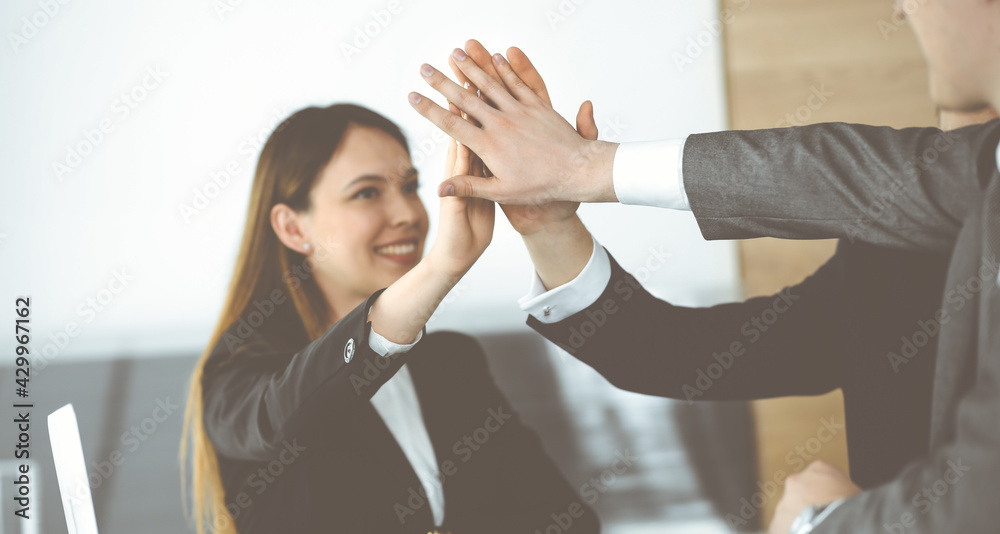 Unknown business people group joining hands in modern office. Businessmen and women making circle with their hands as a team, close-up Unknown business people group joining hands in modern office. Businessmen and women making circle with their hands as a team, close-up