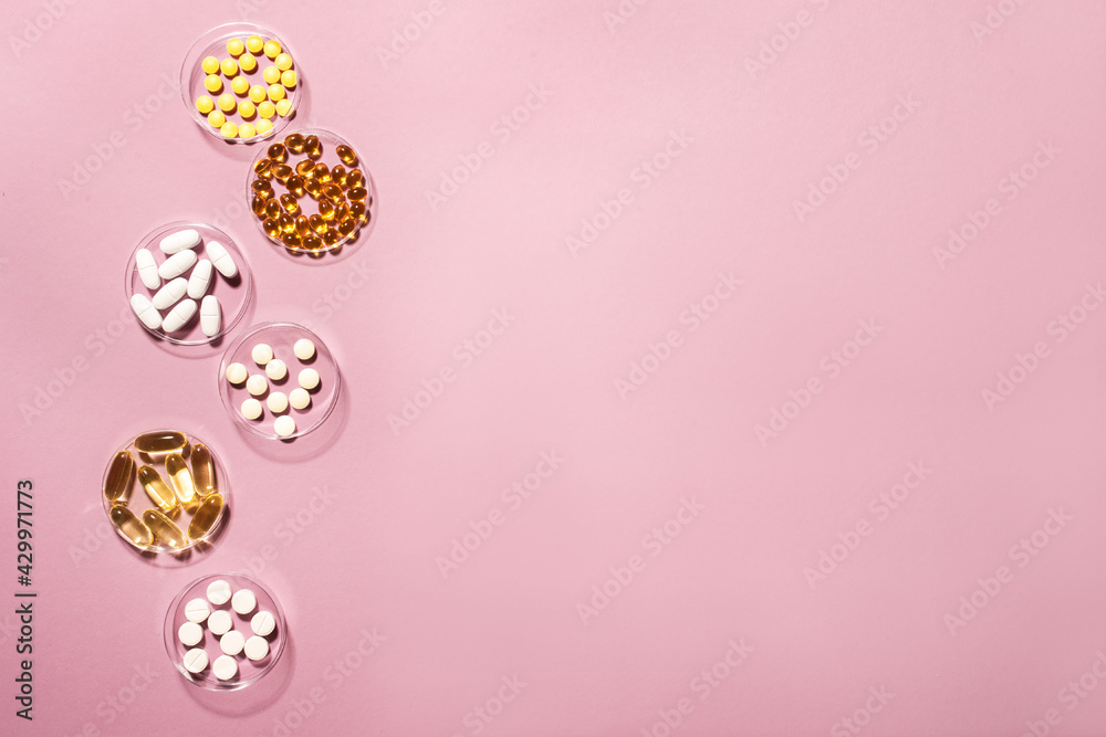 Various pills on pink background Various pills on pink background