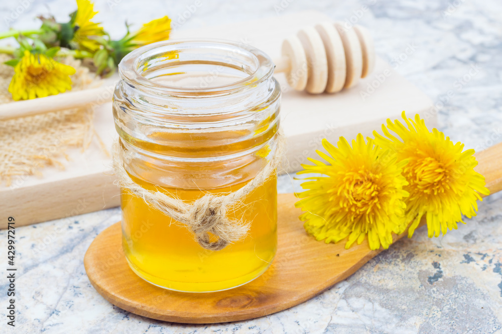 Dandelion honey in a jar and fresh flowers,
beautiful composition Dandelion honey in a jar and fresh flowers,
beautiful composition