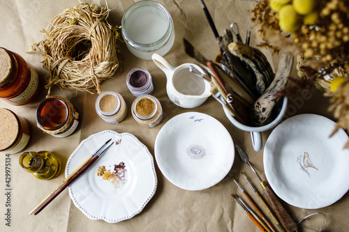 Hand-painting homemade ceramic dishes.