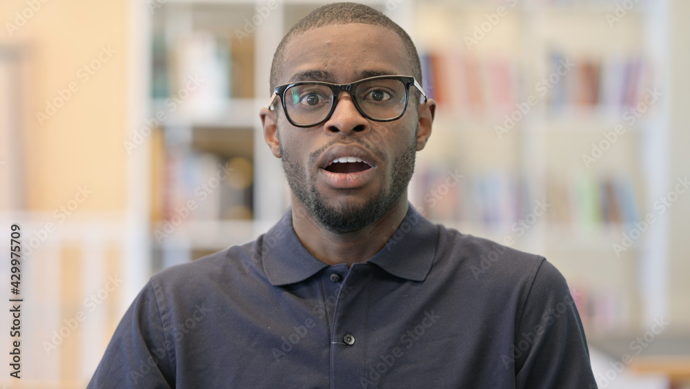 Fototapeta premium Portrait of Upset Young African Man feeling Shocked