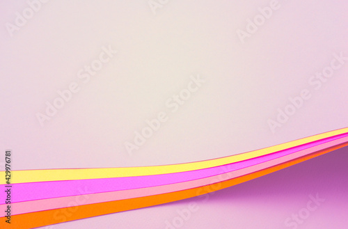 Beautiful fancy arch of curved layers papers. Colorful abstract texture background. Pastel pink, light purple and yellow burnt sienna colored blank papers.
