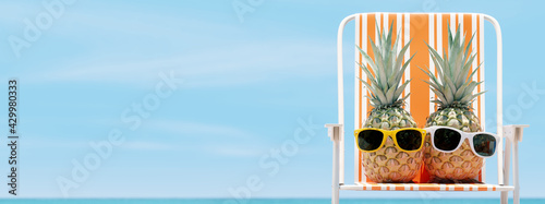 Tropical beach, hipster pineapples on chair with sky background. 3d rendering