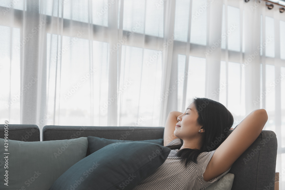 Asian woman relax and sleep on sofa at home Asian woman relax and sleep on sofa at home