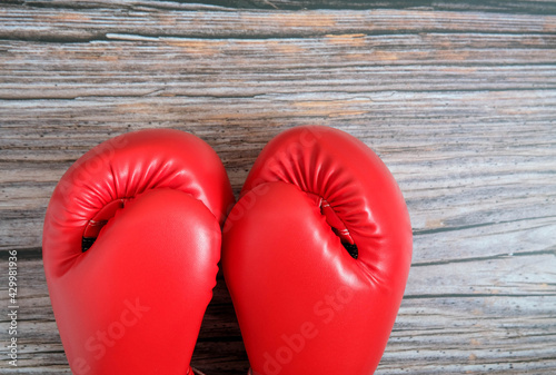 A pair of boxing glove are placed on the table.