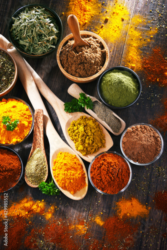 Fototapeta Naklejka Na Ścianę i Meble -  Variety of spices on wooden kitchen table.
