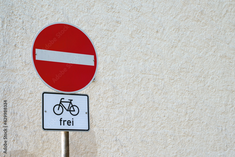 No entry traffic sign on the background of a white wall. Sign with a bicycle under it. No entry traffic sign on the background of a white wall. Sign with a bicycle under it.