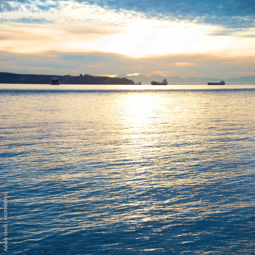 Sunset on sea. Landscape with ships on sunset sea