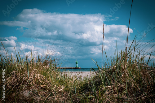 behind the dunes is a lighthouse of Travemuende