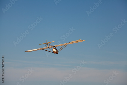 Motorless aircraft glider with pilot in the sky photo