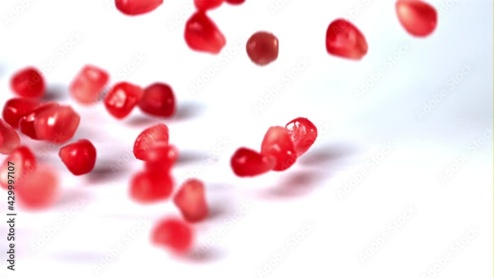 Super slow motion pomegranate grains fall on the table. On a white background.Filmed on a high-speed camera at 1000 fps. High quality FullHD footage Super slow motion pomegranate grains fall on the table. On a white background.Filmed on a high-speed camera at 1000 fps. High quality FullHD footage