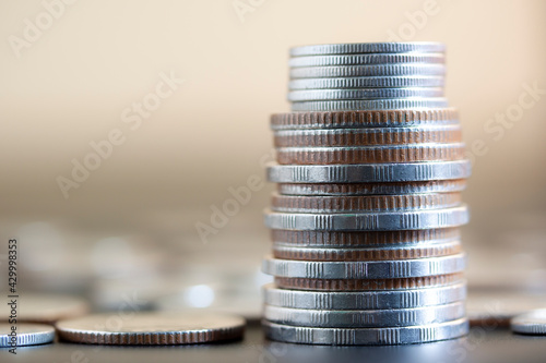 Close up stacks of coin on table background to show concept saving money, business, financial investment, step to growth together.