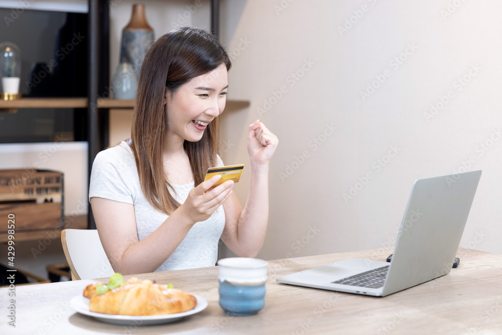 Asian woman use laptop computers to enter credit card information for online purchases. Asian woman use laptop computers to enter credit card information for online purchases.