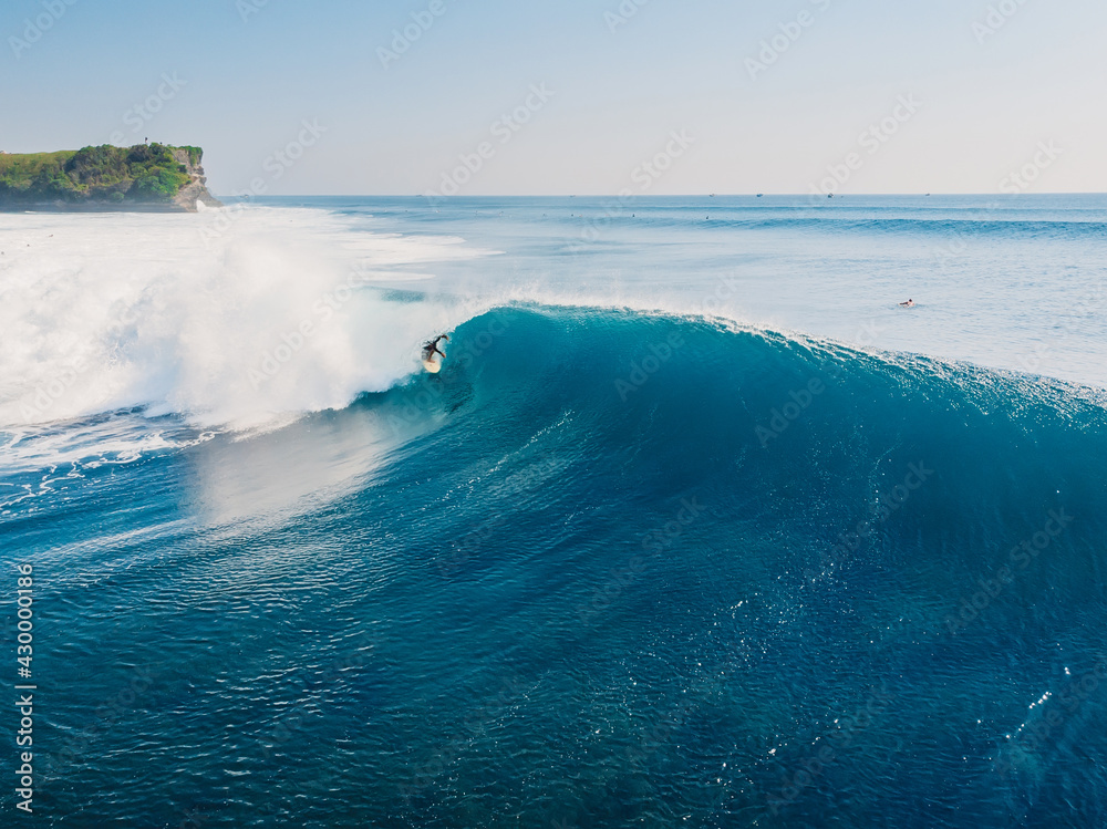 Obraz premium Aerial view with surfing on ideal wave. Blue perfect waves and surfers in ocean