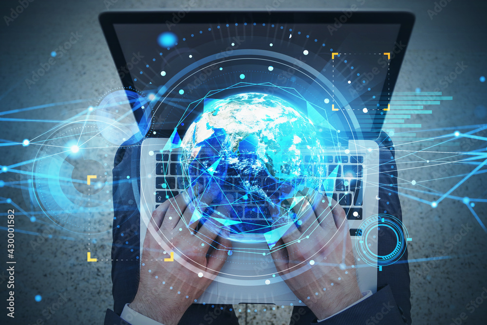 Top view shot of businessman working on laptop. Fintech industry at international business. Planet Earth and tech interface. Elements of this image furnished by NASA