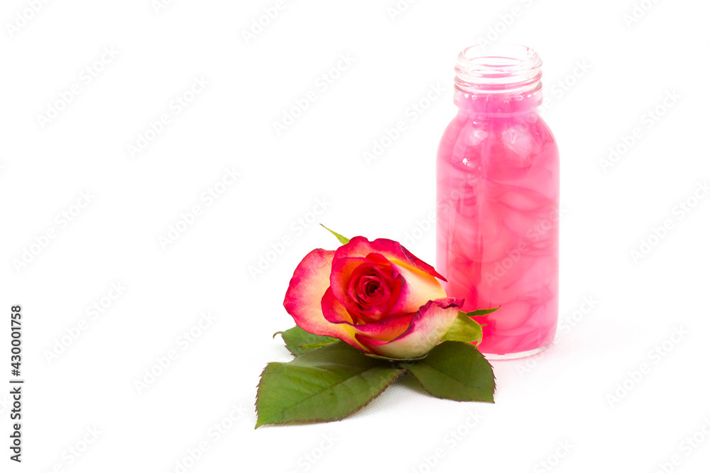 bath oil and pink roses on white background bath oil and pink roses on white background