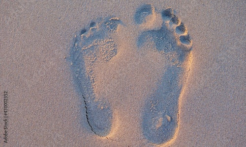 Two well-shaped human footprints in the sand