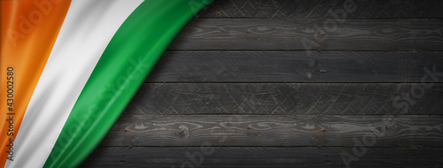 Ivorian flag on black wood wall banner photo