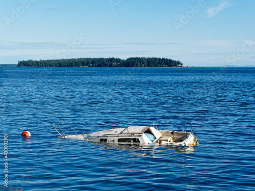 Sunken boat floats in the coastal waters near shore of Sidney BC