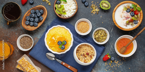 Healthy breakfast set with corn porridge, yogurt, berries, coffee and granola. Top view. Flat lay