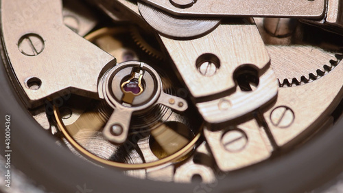Automatic watch movement closeup macro showing hair balance spring moving and ruby jewels