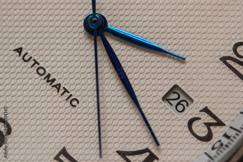 Automatic watch movement closeup macro showing with time hands moving