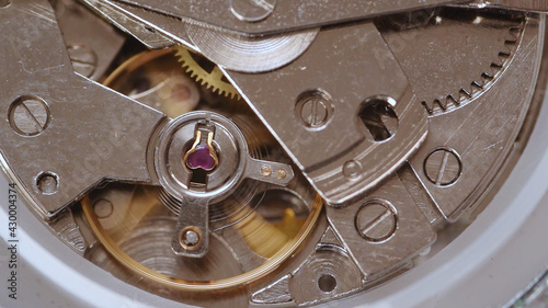 Automatic watch movement closeup macro showing hair balance spring moving and ruby jewels